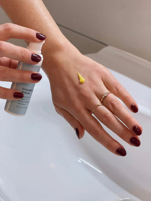 Daily Glow Up Vitamin C Serum wird als leichte Textur auf die Hand aufgetragen.